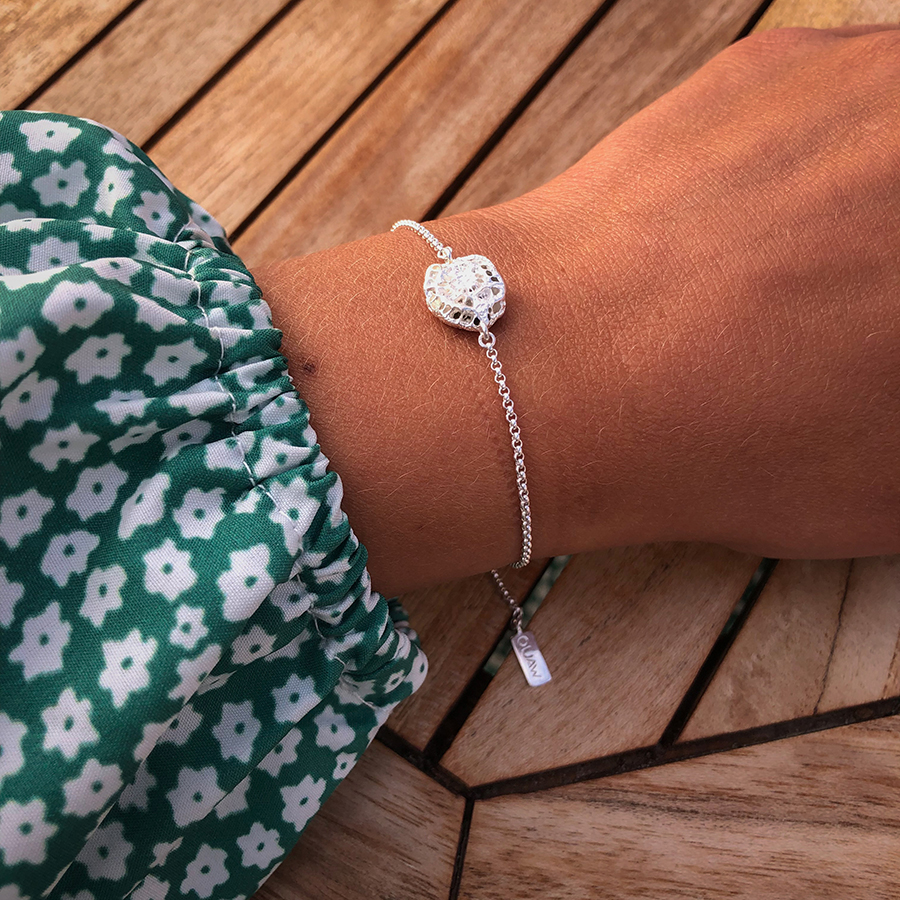 Suna Tsubo bracelet on flowery hand Silver bracelet shaped as a flowerlike grain of sand on woman